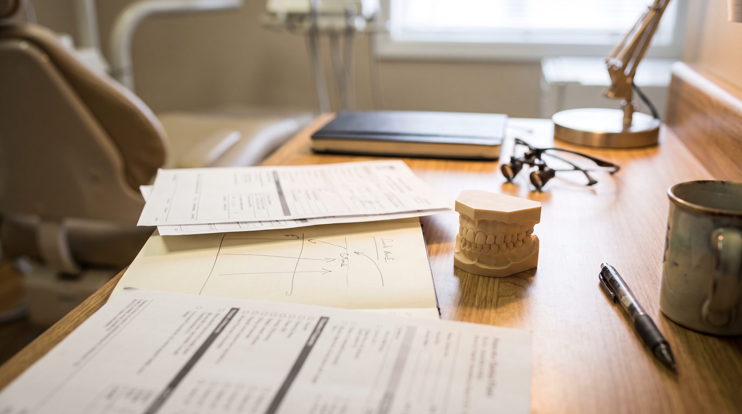 Dental practice financial records on a desk