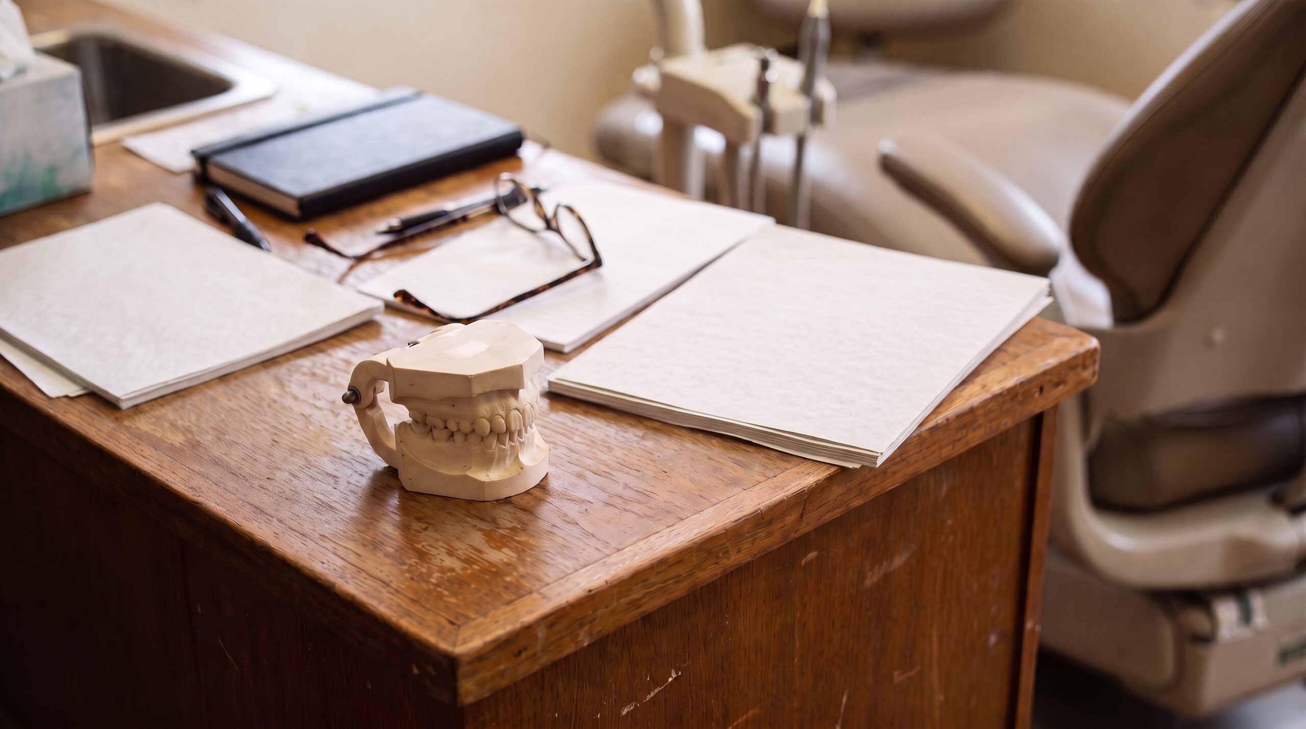 Dental practice financial records on a desk